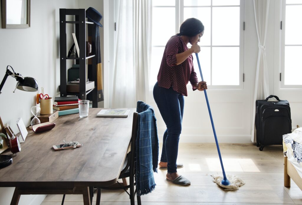 Black woman cleaning room